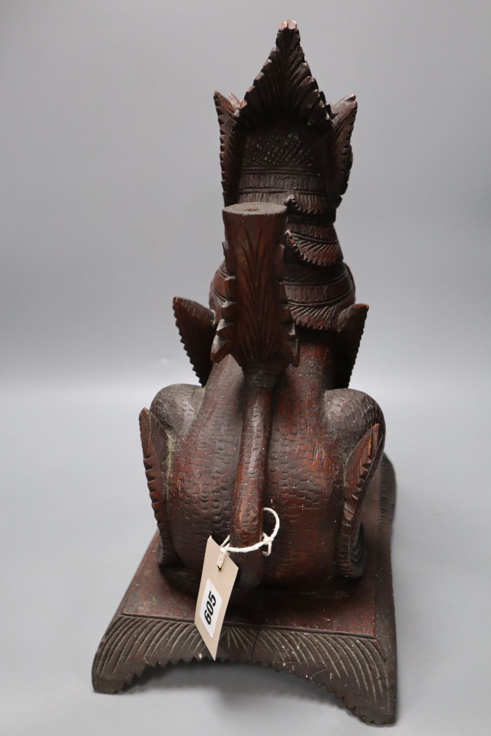 An Indonesian large carved wood model of a seated kylin, on plinth base and two Chinese rootwood carvings of elders, H approx 44cm (kyl